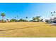 Lush green lawn with shade trees, benches, and fountains on a clear day in this amenity rich community at 421 Leisure World --, Mesa, AZ 85206