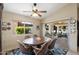 Welcoming dining area with a rustic wooden table, a ceiling fan, and access to a screened patio at 421 Leisure World --, Mesa, AZ 85206