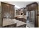 Spacious kitchen featuring dark wood cabinets, granite countertops, and stainless steel appliances at 421 Leisure World --, Mesa, AZ 85206