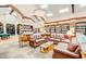 Community library with sofas, tables, chairs, and bookshelves stocked with an array of books for residents enjoyment at 421 Leisure World --, Mesa, AZ 85206