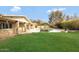 Spacious backyard featuring green grass, a pool, and views of the surrounding mountains at 4349 E Stanford Dr, Phoenix, AZ 85018