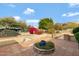 Inviting backyard patio with brick accents and desert landscaping, perfect for outdoor entertaining at 4349 E Stanford Dr, Phoenix, AZ 85018