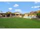 Spacious backyard showcasing green grass, an in-ground pool, and distant mountain views at 4349 E Stanford Dr, Phoenix, AZ 85018