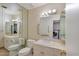 Bathroom with a large mirror, vanity with a sink, toilet, and grab bars for accessibility at 4349 E Stanford Dr, Phoenix, AZ 85018