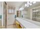 A bathroom with a long vanity counter, large mirror, framed shower, and separated bathtub at 4349 E Stanford Dr, Phoenix, AZ 85018