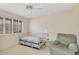 Cozy bedroom design with a daybed, plush armchair, glass side table, and bright window at 4349 E Stanford Dr, Phoenix, AZ 85018