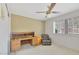 A bedroom featuring a brick accent wall, desk and chair, and window with shutters at 4349 E Stanford Dr, Phoenix, AZ 85018