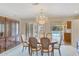 Open dining space with chandelier and sliding door access to the backyard pool area at 4349 E Stanford Dr, Phoenix, AZ 85018