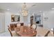 Well-lit dining room with stylish chandelier and views into adjacent living spaces at 4349 E Stanford Dr, Phoenix, AZ 85018