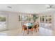 Dining room boasts natural light from large windows and doors, accented by an elegant chandelier at 4349 E Stanford Dr, Phoenix, AZ 85018