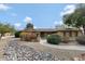 Charming single-story home featuring a landscaped front yard with desert landscaping and a brick walkway at 4349 E Stanford Dr, Phoenix, AZ 85018