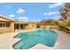 Backyard pool featuring clear blue water, a brick home, and landscaped greenery at 4349 E Stanford Dr, Phoenix, AZ 85018