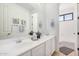 Bright bathroom featuring double sinks, large mirror, white cabinets, and granite countertops at 4376 S Summit E St, Gilbert, AZ 85297