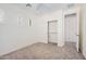 Bedroom featuring neutral carpet, closet and an adjacent door at 4376 S Summit E St, Gilbert, AZ 85297