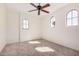 Minimalist bedroom with neutral carpet, ceiling fan, and arched windows at 4376 S Summit E St, Gilbert, AZ 85297