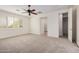 Large bedroom with walk-in closet and window with plantation shutters at 4376 S Summit E St, Gilbert, AZ 85297