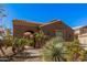 Inviting desert home featuring an arched entryway, low maintenance desert landscaping, and a terracotta tile roof at 4376 S Summit E St, Gilbert, AZ 85297