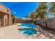 Inviting backyard pool and spa area perfect for relaxation and entertaining, complete with palm trees and patio at 4376 S Summit E St, Gilbert, AZ 85297