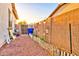 View of the backyard featuring gravel, a white fence, and various bird feeders at 4545 S Ellesmere St, Gilbert, AZ 85297