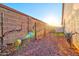 Backyard view with block wall, green grass, and desert landscaping at 4545 S Ellesmere St, Gilbert, AZ 85297