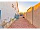 View of the backyard featuring gravel, a white fence, and the exterior of the home at 4545 S Ellesmere St, Gilbert, AZ 85297