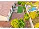 Aerial view of a backyard with a patio, artificial turf, lush greenery, and a pool at 4545 S Ellesmere St, Gilbert, AZ 85297