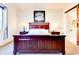 Bedroom showcasing a wooden bed, bedside tables, and window with patterned curtains at 4545 S Ellesmere St, Gilbert, AZ 85297