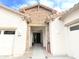 Close up of the exterior entrance of a single-Gathering home with stone detail, stucco exterior, and two-car garage at 4545 S Ellesmere St, Gilbert, AZ 85297