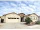 Inviting single-story home featuring desert landscaping, neutral stucco, stone accents, and a two car garage at 4545 S Ellesmere St, Gilbert, AZ 85297