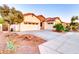 Charming single-story home with a three-car garage, desert landscaping, and a stone accent entry at 4545 S Ellesmere St, Gilbert, AZ 85297