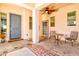 Welcoming front porch with a ceiling fan, a table, and stylish seating at 4545 S Ellesmere St, Gilbert, AZ 85297