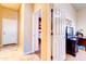 Hallway view into an office and bedroom with tiled floors and white doors and trim at 4545 S Ellesmere St, Gilbert, AZ 85297