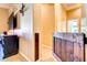 Hallway featuring a decorative wood gate, tile flooring, and television mounted on the wall at 4545 S Ellesmere St, Gilbert, AZ 85297