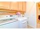 Laundry room with cabinets, countertop and utility sink, plus washer and dryer at 4545 S Ellesmere St, Gilbert, AZ 85297