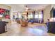 Open-concept living room with tile flooring, a ceiling fan, and plenty of natural light at 4545 S Ellesmere St, Gilbert, AZ 85297