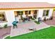 View of patio with outdoor seating and a grill, with an artificial turf area and lush greenery at 4545 S Ellesmere St, Gilbert, AZ 85297