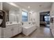 Bathroom featuring a large soaking tub, double vanity, walk-in shower, and access to the main bedroom at 4593 W Bush Bean Way, San Tan Valley, AZ 85144