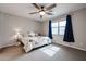 Neutral bedroom featuring a patterned comforter, ceiling fan, and natural light from the window at 4593 W Bush Bean Way, San Tan Valley, AZ 85144