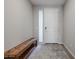 Entryway with tile flooring, light gray walls, a wooden bench, and door to the house at 4593 W Bush Bean Way, San Tan Valley, AZ 85144