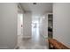 Hallway with tile flooring, light gray walls, and a wooden bench at 4593 W Bush Bean Way, San Tan Valley, AZ 85144