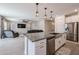 Open-concept kitchen with granite countertops, stainless steel appliances, and island perfect for entertaining at 4593 W Bush Bean Way, San Tan Valley, AZ 85144