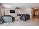 Comfortable living room with a large couch, ceiling fan, and natural light at 4593 W Bush Bean Way, San Tan Valley, AZ 85144