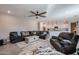 Open concept living room showcasing a large sectional sofa and adjacent modern kitchen at 4593 W Bush Bean Way, San Tan Valley, AZ 85144