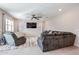 Bright living room boasts plush seating, ceiling fan, neutral tones, and lots of natural light at 4593 W Bush Bean Way, San Tan Valley, AZ 85144