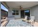 A covered patio features comfortable lounge chairs, a ceiling fan, and backyard views at 4593 W Bush Bean Way, San Tan Valley, AZ 85144