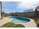 Backyard oasis featuring a sparkling pool and putting green at 4593 W Bush Bean Way, San Tan Valley, AZ 85144