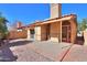 Enclosed backyard with desert landscaping, brick borders, privacy walls, and a covered patio area at 4843 W Del Rio St, Chandler, AZ 85226