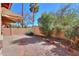 Enclosed backyard with desert landscaping, brick borders, privacy walls, and a covered patio area at 4843 W Del Rio St, Chandler, AZ 85226