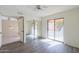 Bedroom with vinyl wood-look flooring, mirrored closet doors, and sliding glass door at 4843 W Del Rio St, Chandler, AZ 85226