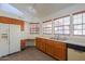 Bright kitchen with white appliances, oak cabinets, and plenty of counter space at 4843 W Del Rio St, Chandler, AZ 85226